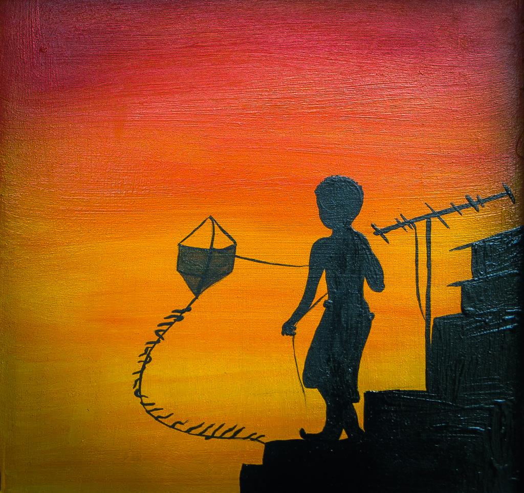 Garoto com pipa ao pôr do sol